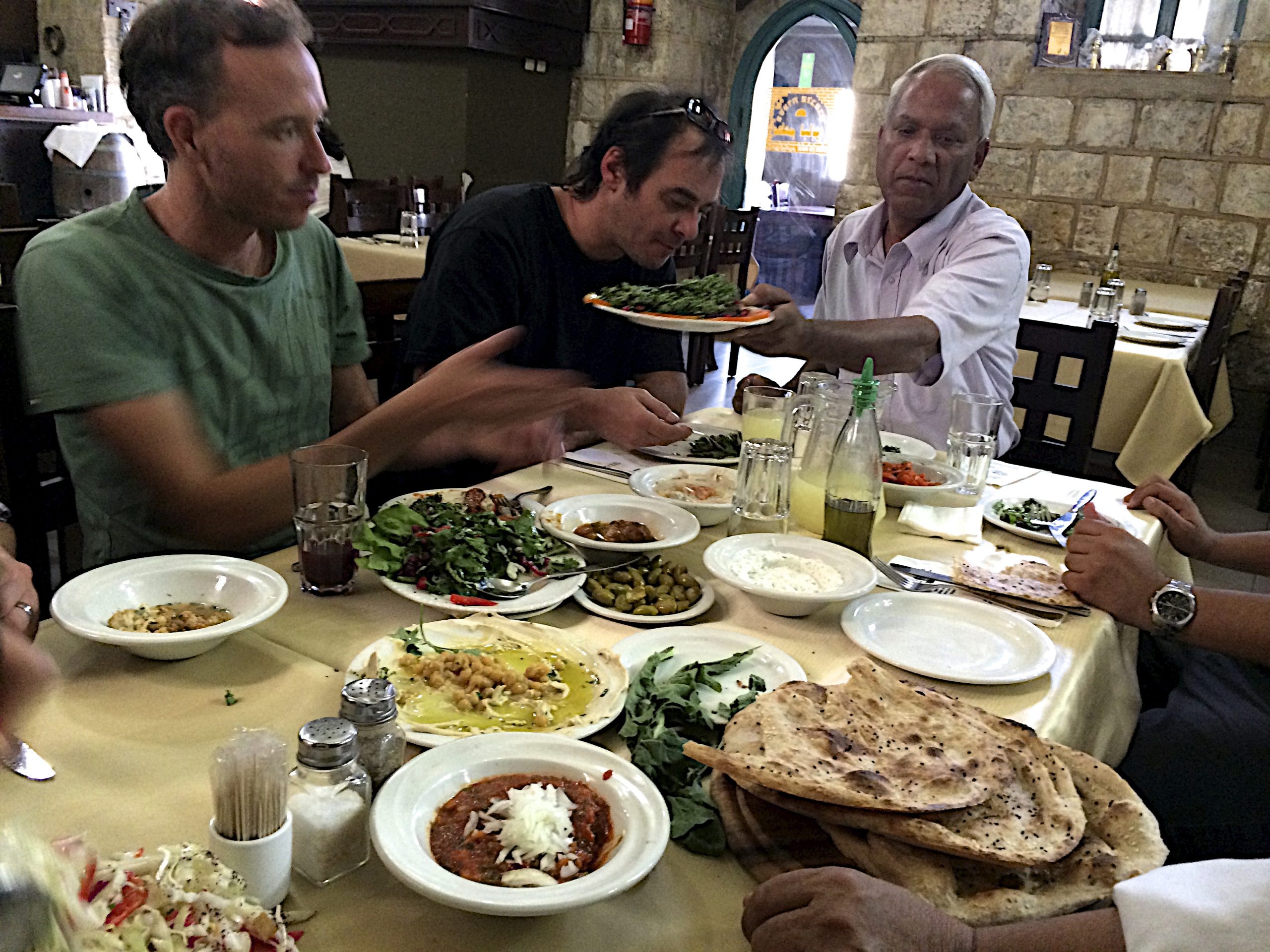 a table full of Israeli Cuisine being enjoyed by our film crew.